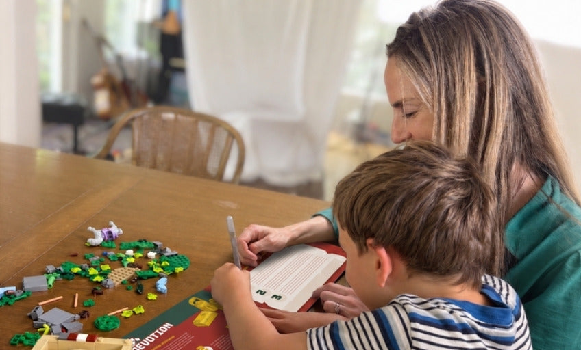 A mom and son building together at the table